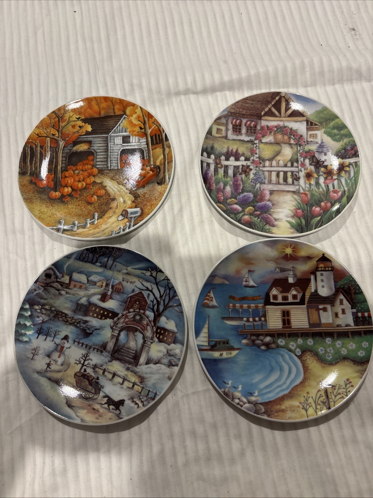 Vintage set of four decorative plates from 1980, each depicting The 4 Seasons