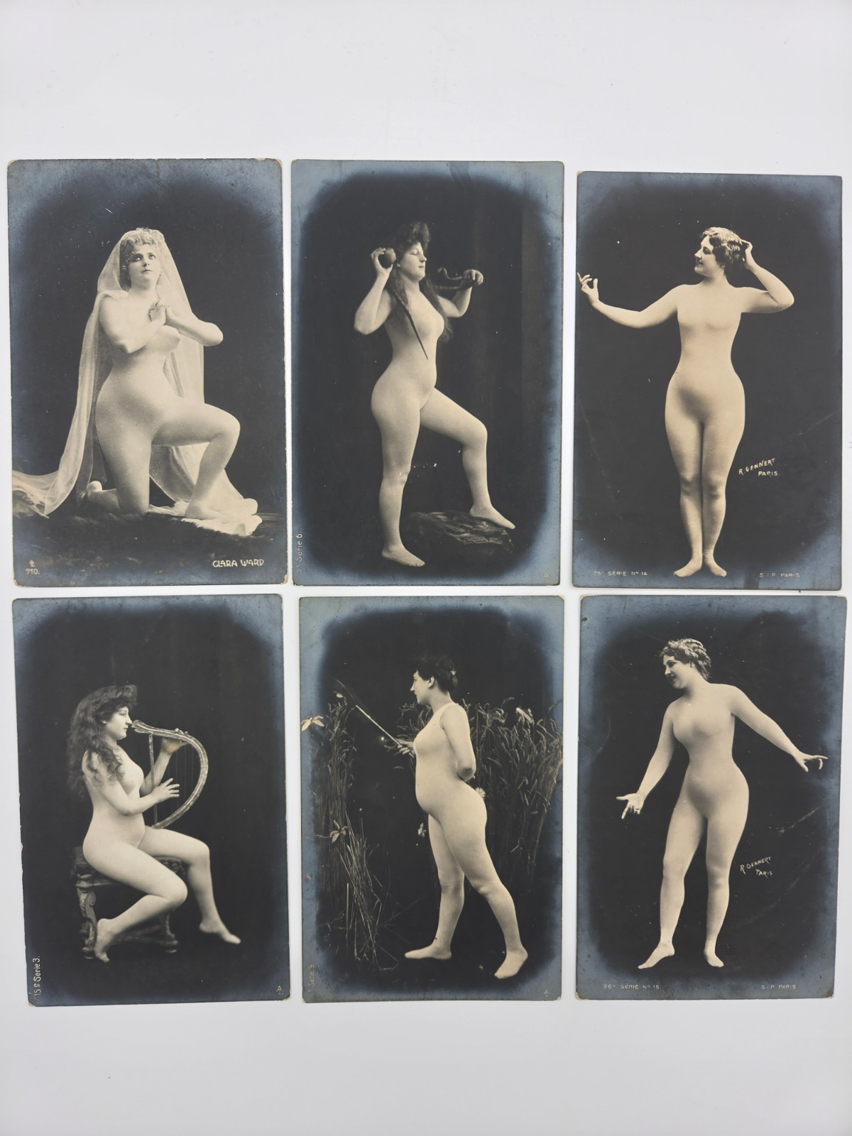 Six antique postcards featuring a lady in a 