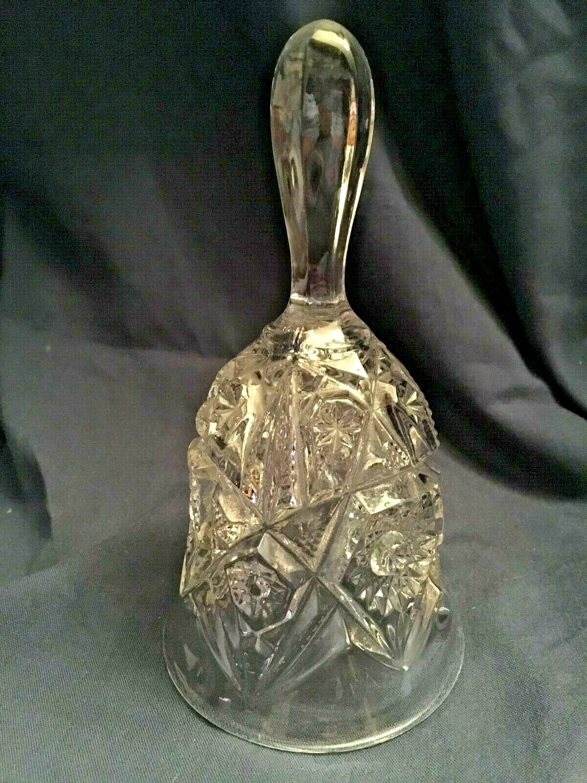 pressed glass bell.  Clear. Clapper is clear.  7 inches