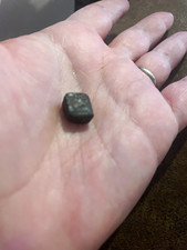 Small Dark Stone Specimen Possible Meteorite or Tektite Photo in Hand picture
