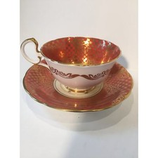 Aynsley teacup and saucer in tropical gilt pattern over dark salmon color picture