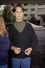 Wil Wheaton wearing a green crew-neck top beneath a black v-neck s- Old Photo picture