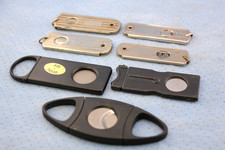 SEVEN VINTAGE HAND HELD CIGAR CUTTERS picture
