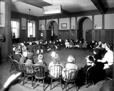 Little kids sitting in a circle in chairs circa early 1900s Old Photo picture