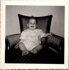1950s Black and White Photo of Infant in Upholstered Chair, Classic Family Momen picture