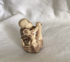 Vintage Netsuke-Style Figurine of a Monk Riding on a Goose picture