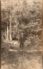 Postcard Real Photo RPPC Man Wearing Hat Standing on Wooded Lot Unposted picture