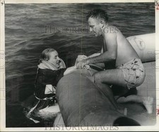 1954 Press Photo Stephen Hamilton of Coast Guard helps stewardess Betty Hammack picture
