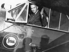 Clyde Pangborn is seated in the cockpit of his plane waving goodbye Old Photo picture