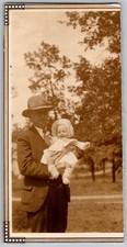 Vtg B&W Snapshot Man in Suit And Hat Holding Baby in Bonnet Outdoors 1920s picture