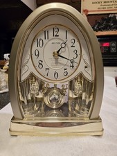 Rhythm Joyful Crystal Gold Musical Mantel Clock swinging crystal pendulum picture
