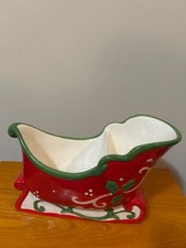 ceramic sleigh is a festive dish often used for candy or as a holiday centerpiec picture