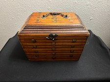 This vintage wooden box is an elegant accent to any decor. The metal handle and  picture