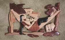 Tiki Wall Art. Wood Sculpture of Native Woman Feeding Baby in Hammock picture