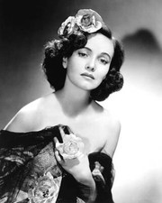 Teresa Wright with flowers in her hair as well as holding flowers- Old Photo picture