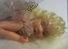 Vintage miniature  hand crafted angel doll laying on a cloud picture