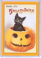 VINTAGE REPRODUCTION SMILE IT'S HALLOWEEN BLACK CAT IN PUMPKIN REPRO POSTCARD  picture