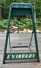 vintage Evinrude outboard boat motor stand picture