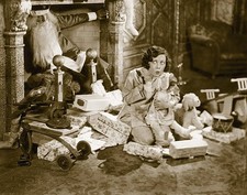 Comedienne Marion Byron sitting in front of fireplace listening fo- Old Photo picture