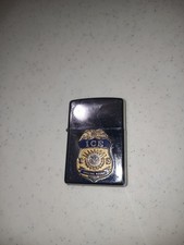 Zippo lighter featuring a gold and blue U.S. Immigration and Customs Enforcement picture