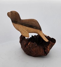 Hand-Carved Soro Wood Seal Figurine on Natural Base picture