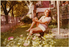 FOUND PHOTO - Pretty brunette in short shorts posing in garden 1970s picture