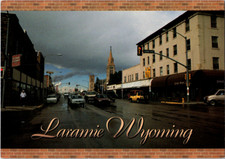 Vintage Postcard Laramie Wyoming Downtown Streets And Iconic Church picture