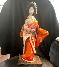 Vintage Japanese Geisha Doll Orange Kimono on Wooden Stand. picture
