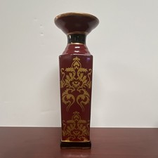 The flared lip of this red vase is solid crimson with a gilded gold edge. picture