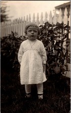 [4M2] Postcard Unused RPPC, Little Girl in Garden Pickett Fence picture