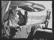 Photo:Oilfield Worker at Wellhead 1930s Desert Drilling Rig picture