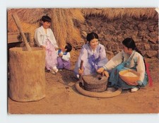 Postcard Woman Grinding Her Grains picture