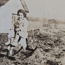 Vintage B&W Photo Snapshot of Young Child on Rocking Horse Outside in Lawn picture