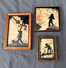 3 silhouettes. wood framed. Milkweed/wildflower backdrop. Kids in nature picture