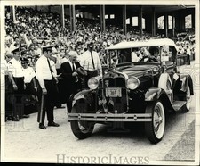 Press Photo An old time automobile arrives at a stadium  - net10631 picture