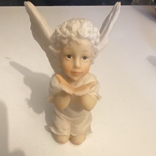 This image features a vintage ceramic bisque or porcelain cherub angel figurine. picture