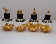 Pure Gold Flakes 24k in a Strong Bottle With Miniture Pewter Figure On The Cap picture