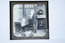 Man Lighting Oil Lamp Cottage Interior Lagge Magic Lantern Slide c1900s picture