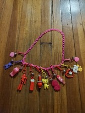 Vintage 1980s Plastic Bell Charm Necklace Pink W/ 12 Charms picture