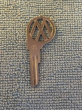 Uncut vintage Volkswagen logo key blank unnotched blade stamped with 