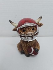 Adorable Highland Cow With Football picture