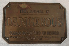 Embossed Antique Brass Tone Metal Wall Sign “This Animal Is Dangerous” picture