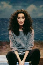 Cher sits in front of a beach backdrop in 1983 Old Photo picture