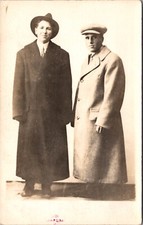 Real Photo Postcard Two Men Wearing Large Coats and Hats in a Photo Studio picture