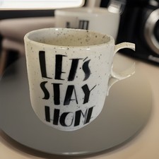 Anthropologie Cabin In The Trees “LET’S STAY HOME” Coffee Tea Mug White w/ black picture