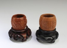 A Group of Two Carved Walnut Ornament. Comes fitted with a wooden stand picture