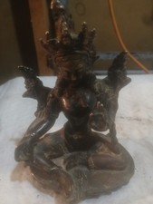 This object is a Tibetan bronze statue of Green Tara, the Buddhist deity of comp picture