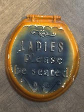 Vintage ceramic sign with the phrase 'Ladies Please be seated' embossed on it. picture
