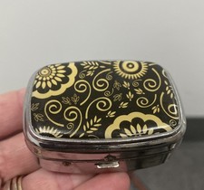 Retro Hinged 2 Slot Pill Box. Yellow Black Flower. W/ Mirror. 2.1/4 “L x 1” T A picture