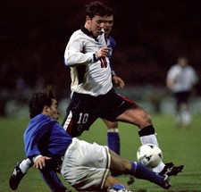 England's Matt Le Tissier leaps over the Italian defence during to- Old Photo picture